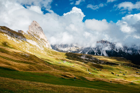 Seceda in the Dolomites with rolling green hills and dramatic clouds