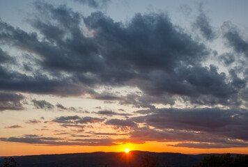 Cloudscape as the sun sets near the horizon illuminating a sunse