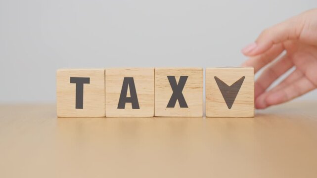 hand change wooden block with TAX text to UP and Down arrow icon. decrease and Increase, Taxpayer, Taxable Income, Tax Filing, Deduction, Withholding Tax, WHT, VAT, Computation and Exemption concept