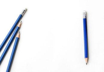 Isolated blue pencils on a white background with copy space. Concept of education, creativity, writing, learning, office supplies, and clean modern design. Top shot, horizontal orientation, flat lay © Tanya_Tet