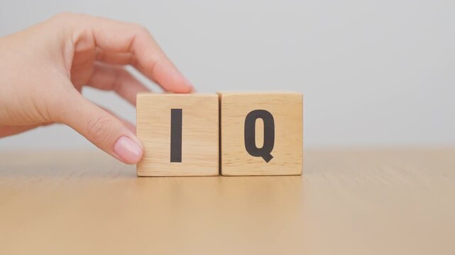 hand change wooden block from IQ to EQ, balance between intelligence quotient and emotional quotient, AQ Adversity, MQ, Moral, SQ and Social quotient concepts