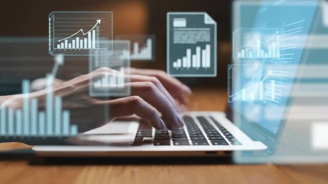 Hands typing on laptop keyboard with floating holographic business charts and financial data documents in professional wooden table setting.