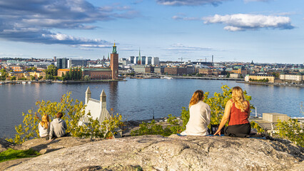 Stockholm, Sweden: Families and friends overlooking the cityscape from a rocky overlook by the water