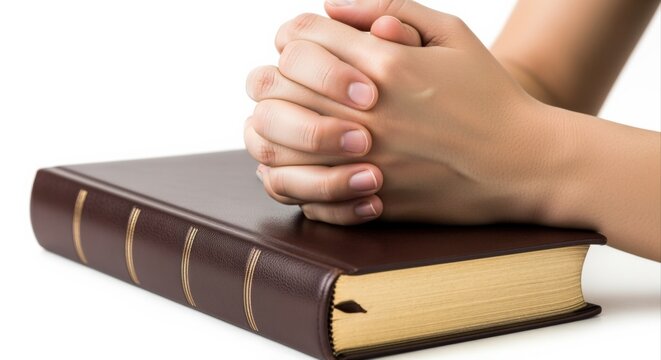 Hands Clasped in Prayer Resting on Bible, Symbolizing Faith, Spirituality, and Religious Devotion