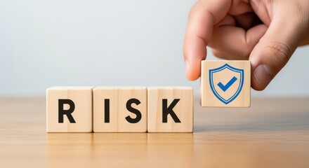 Hand placing a shield with a checkmark on a risk concept with wooden blocks on a table