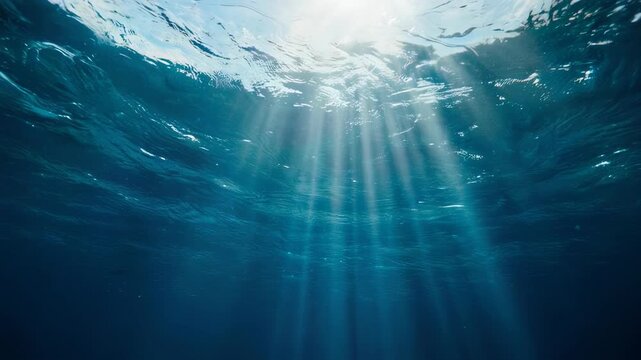 Sunlit ocean depths with rippling water and crepuscular rays