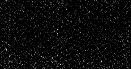 High contrast bubble wrap texture on black background with glowing light reflections. Abstract plastic pattern, futuristic industrial surface, dramatic lighting, creative packaging concept.