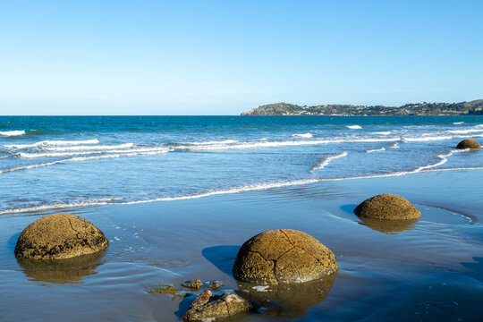 Moeraki boulders on beach with small waves