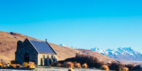 Majestic Lake Tekapo and the Church of the Good Shepherd at sunrise on a cool spring morning