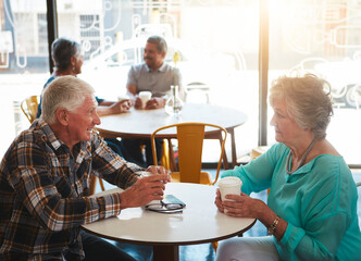 Obraz premium Couple, love and old people in coffee shop for break, morning or retirement together. Date, drink or flare with senior man and woman in cafe or restaurant for bonding, conversation or marriage