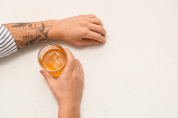 Male hands with glass of rum on white background