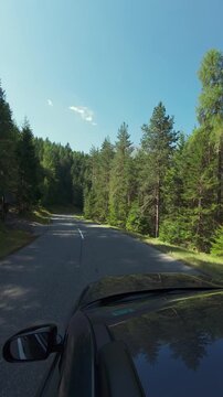 Asto rides along a picturesque mountain road in the middle of the forest. Travel and tourism beautiful mountain landscapes.