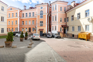 Classic European city courtyard with colorful buildings and parking
