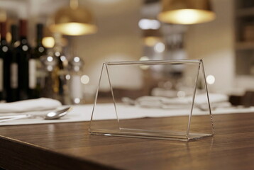 Transparent stand mockup menu frame, table tent , empty stand display on blured cafe background, restaurant, bar . Food menu for text promotion to business advertising