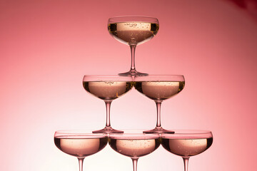 Champagne Glass Pyramid with Bubbles Against a Pink Gradient Background
