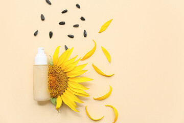 Composition with bottle of cosmetic product, sunflower and seeds on color background