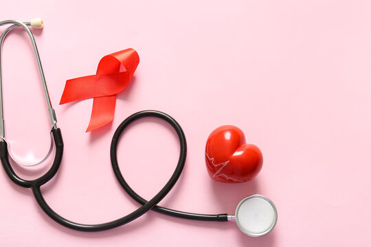 Red ribbon with stethoscope and heart on pink background. Blood Cancer Awareness Month