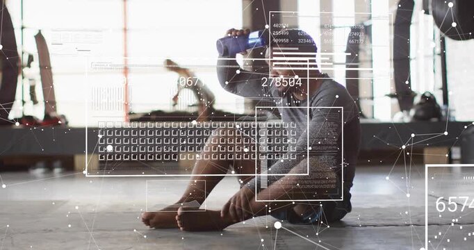 Man reaching for blue bottle during rest to hydrate in fitness studio HUD mapping hydration metrics