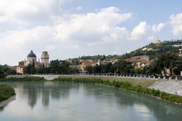 Obraz premium Photo of the beautiful city of Verona in Italy showing the town centre along side the river Adige in the summer time on a sunny day