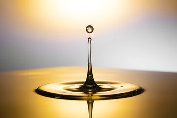 Golden Water Drop Splash Frozen in Time with Ripples