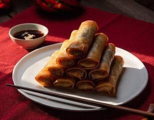 Crispy golden fried spring rolls on plate