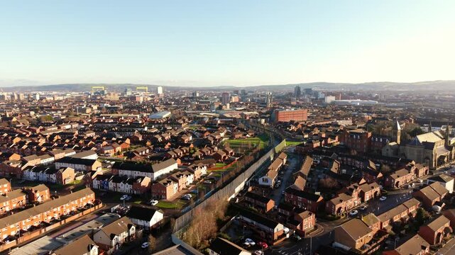 Ultra-wide forward travelling 4K 60FPS aerial video of the Belfast Peace Wall Interface in Belfast, Northern Ireland. The murals explore the politics of NI and worldwide. Produced with Rec709 color.