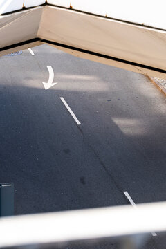 Minimal empty asphalt road texture with arrow markings and street space for transport mobility concepts directional graphic background and navigation