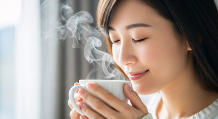 Serene Asian woman enjoying a steaming cup of coffee, conveying warmth, comfort, and relaxation