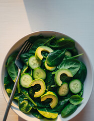 Bowl of fresh green salad with avocado