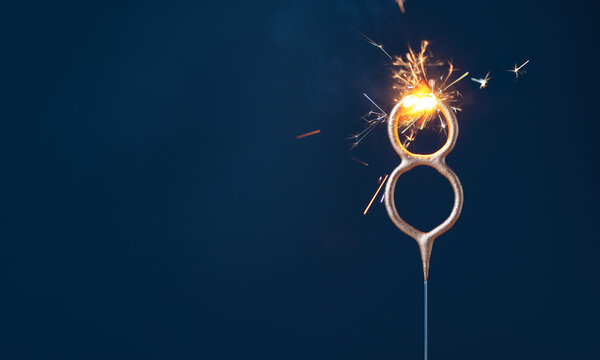8 years celebration festive background with copy space made with Bengal fire in the form of number Eight.