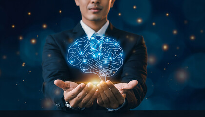 Businessman holding glowing blue brain with hands