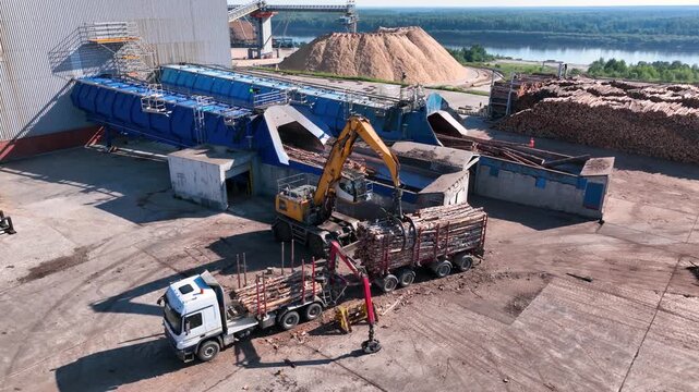 Unloading of wood from a logging truck for further processing. Paper production