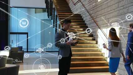 Animation of network of digital icons over asian businessman using smartphone at office - Powered by Adobe