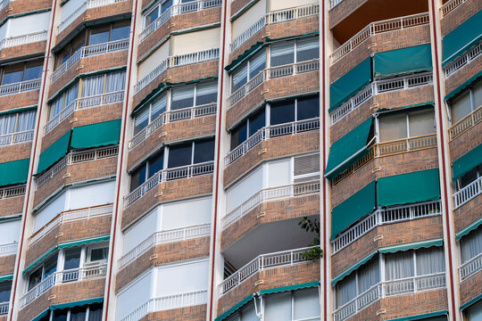 benidorm spain urban facade of apartment residential with balconies and awning showing repetition and pattern in vintage documentary architecture detail