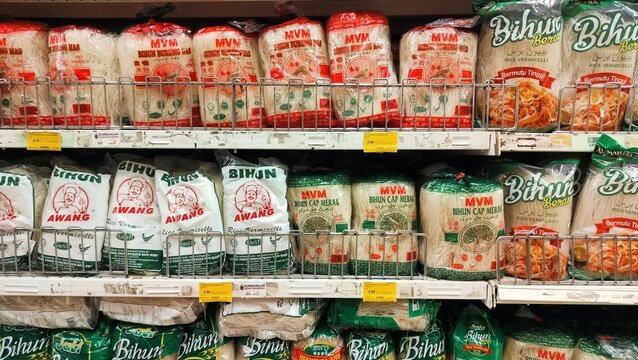 Malaysia, Kuala Terengganu January 21, 2026: various brands of vermicelli for sale. vermicelli display on the shelf in supermarket. Packaged rice vermicelli or bihun bundles
