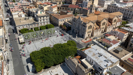 Fototapeta premium Aerial view of Reggio Calabria Cathedral, in Italy. It is a Roman Catholic cathedral in the historic center of the city. Its dedication is to the Assumption of the Virgin Mary. It is a sunny morning.