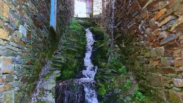 Mountain stream water flowing through a channel in the traditional Portuguese mountain village of Piodao.