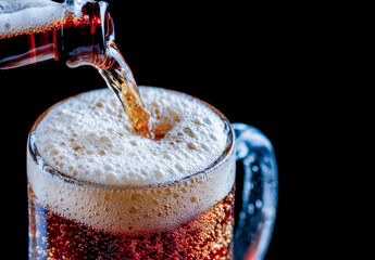 Soda Being Poured into a Mug Creating a Refreshing and Foamy Beverage in Dark Background.