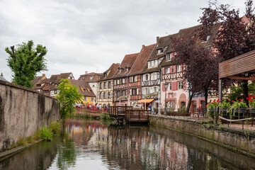 Colmar canal with historic half-timbered houses reflecting water