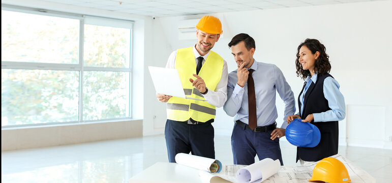 Team of engineers discussing project of building indoors