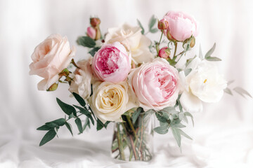 Obraz premium Elegant Valentine bouquet of mixed roses and peonies in pastel tones, styled on minimal white background with soft shadows, perfect for flower shop or greeting card visuals