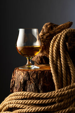 Brandy snifter and rope on a old stumb.