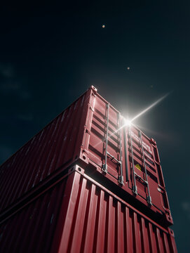 Low angle stacked red shipping containers with dramatic lens flare
