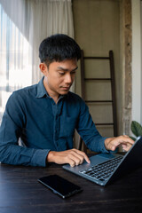 Fototapeta premium lifestyle of office workers Man calculating expenses and using laptop. Home office. Work place. Lifestyle.