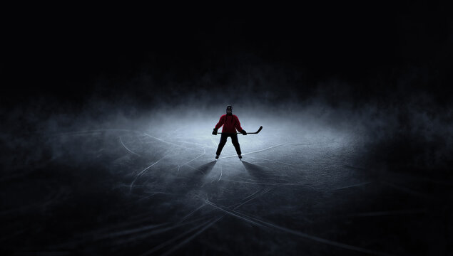 Dramatic artwork ice hockey player standing alone on dark rink. Concept of mental focus before game, professional sport pressure, readiness for competition, dramatic ice background.