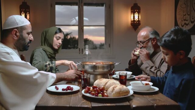 A Muslim family gathered for Iftar in Ramadan - Ramadan pattern, Ramadan background, Ramadan  vibes, Iftar table, iftar time, fasting, food, A-fitr, Suhoor, sunset time, Imsak, Sawm, Siyam, 
