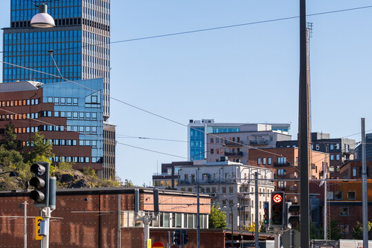 S&ouml;dra Hammarbyhamnen Stockholm modern skyline with tower over urban district street showing city development in daylight under blue sky