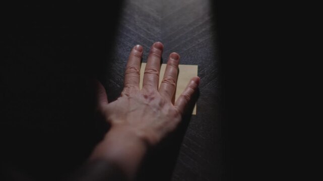 "Rules" written on a Sticky Note with a sharpie and placed on a table under dramatic lighting