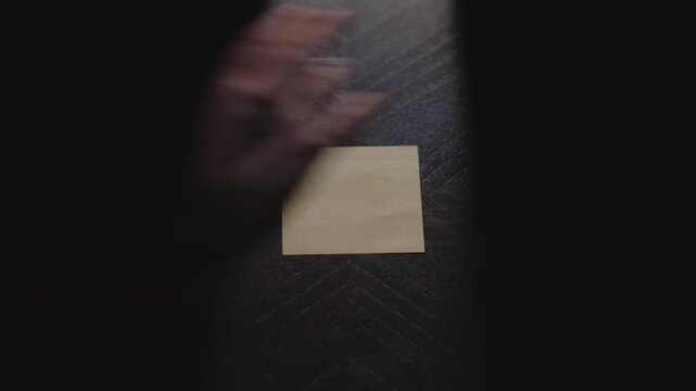 "Q4" written on a Sticky Note with a sharpie and placed on a table under dramatic lighting