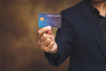 Businessman holding credit card for digital payment concept.